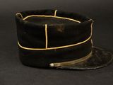 an old black hat on a black background with a leather band
