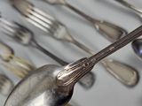 many spoons, forks, and spoon spoons on the table