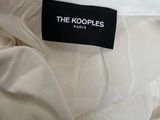the koople label on the back of a white dress
