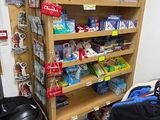 a wooden shelf with various items on it in a store