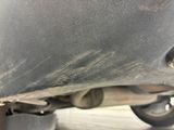 a close up of a car ' s exhaust pipe and exhaust muffler
