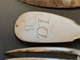 three forks and a spoon sitting on top of a table