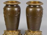 pair of antique brass vases with flowers and leaves on them