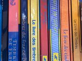 a lot of books that are stacked on a shelf