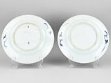 pair of blue and white porcelain plates with floral designs