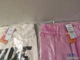 two pairs of pink and white pants sitting next to each other