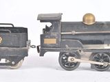 a toy train that is sitting next to another toy train