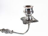 a silver candle holder that has a candle on it