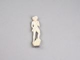 a small ivory figurine of a man with a hat and a cane
