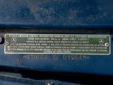 a metal plaque on the back of a blue car