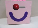 a pink box with a smiley face on top of it