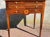 a small wooden table with a drawer on top of it