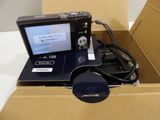 a camera in a box with a charger attached to it