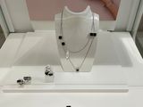 a display case with a necklace, bracelet, and ring on it