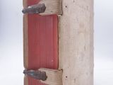 an old book that is open on a white surface
