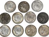 a close up of a bunch of coins on a white surface