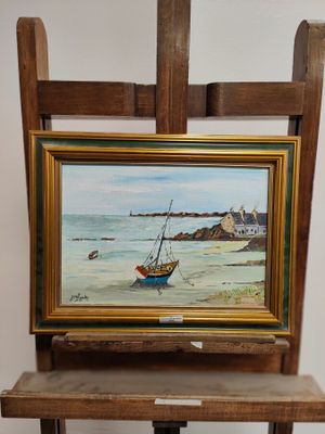 a picture of a painting on a easel next to a chair