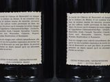 two bottles of wine are sitting on a table next to each other