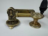 a gold doorknob and a black doorknob on a table