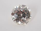 a close up of a diamond on a white surface