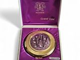 a close up of a purple box with a gold lid