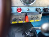 a close up of a car dashboard with a red button