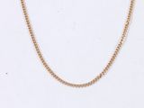 a close up of a gold chain on a white background