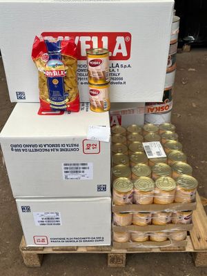 boxes of canned food are stacked on a pallet in a warehouse