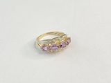 a close up of a gold ring with amethorate and diamonds