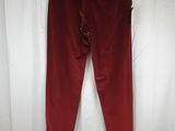 a pair of red pants hanging on a white curtain
