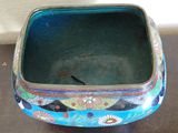a small blue bowl with flowers on it sitting on a table