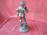 antique bronze figurine of a boy holding a bird