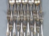 a lot of silver spoons and forks on the table