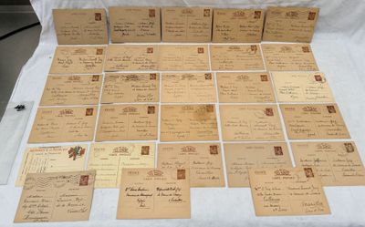 many old letters and envelopes laid out on a table