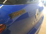 a close up of a blue car with a sticker on it