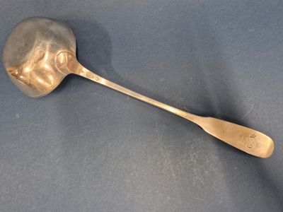 silver spoon with a wooden handle on a blue surface