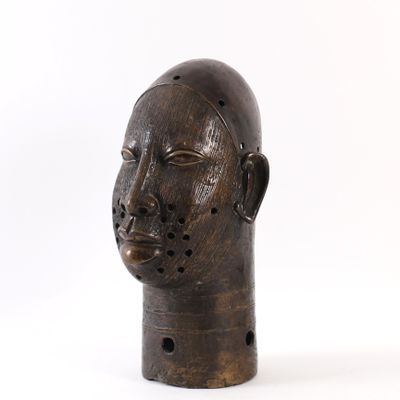 a wooden sculpture of a man ' s head on a white background