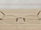 a pair of glasses sitting on a wooden table