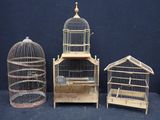 three small wooden bird cages sitting next to each other on a black surface