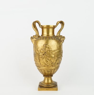 an image of a gold vase sitting on top of a white surface
