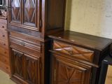 two wooden cabinets and a tv stand in a room