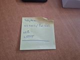 a piece of paper on the floor with a note attached to it