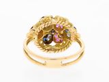 a close up of a gold ring with blue and pink stones