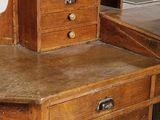 a wooden desk with drawers and a mirror on top of it