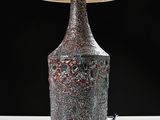 a lamp that is sitting on a table with a shade on it