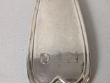 a silver spoon that is sitting on a table