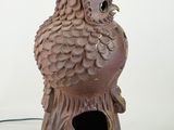 a bird that is sitting on top of a birdhouse