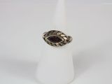 a silver ring with a garnet stone in the center