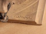 a close up of a metal object on a wooden surface