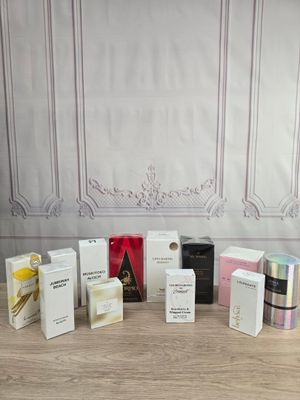 various types of perfumes and boxes on a table